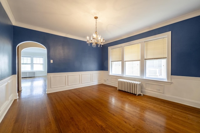 6712 N Maplewood Ave, Chicago, IL 60645 - empty room featuring radiator heating unit, radiator, a chandelier, wainscoting, and ornamental molding