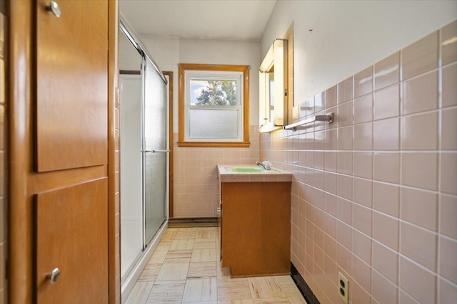 200 S Madison St, Towanda, IL 61776 - bathroom featuring vanity, tile walls, a stall shower, and tile patterned floors