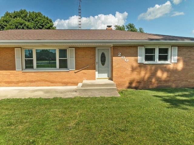 200 S Madison St, Towanda, IL 61776 - single story home featuring brick siding, a front yard, a chimney, and roof with shingles