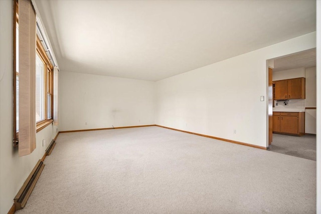 200 S Madison St, Towanda, IL 61776 - unfurnished room featuring light carpet and a baseboard heating unit