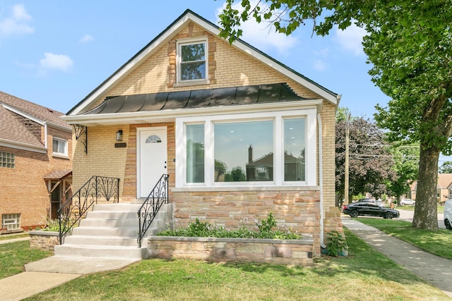 2263 S 14th Ave, North Riverside, IL 60546 - bungalow-style house with a standing seam roof, a front yard, a metal roof, and brick siding