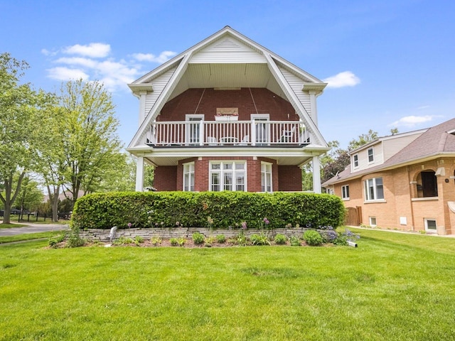 718 S Washington Ave, Park Ridge, IL 60068 - view of front of house featuring brick siding, a balcony, a front yard, and a gambrel roof