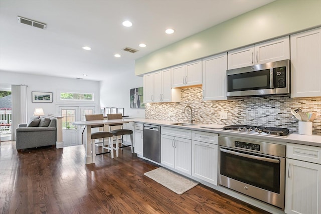 718 S Washington Ave, Park Ridge, IL 60068 - kitchen with stainless steel appliances, light countertops, decorative backsplash, recessed lighting, and dark wood-style flooring
