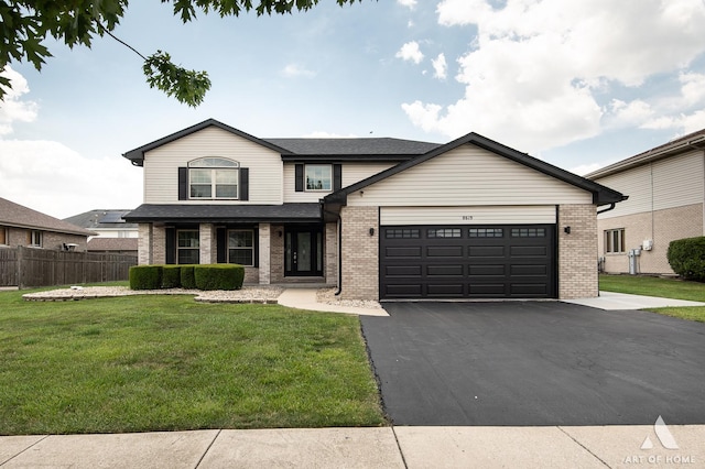 8619 Koehler Dr, Tinley Park, IL 60487 - view of front of home featuring brick siding, driveway, a garage, and roof with shingles