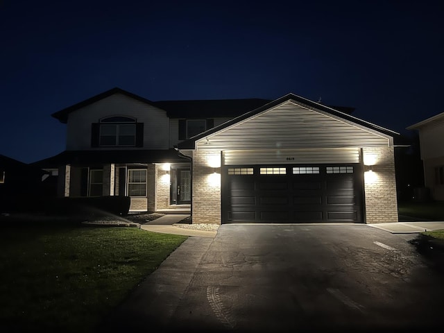 8619 Koehler Dr, Tinley Park, IL 60487 - traditional home featuring asphalt driveway, an attached garage, and brick siding