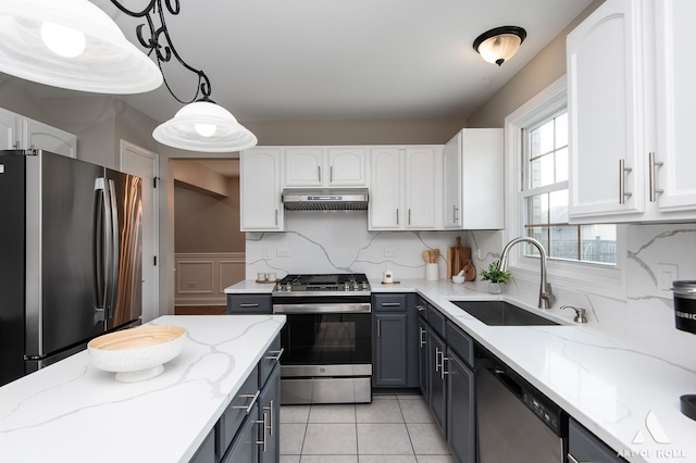 8619 Koehler Dr, Tinley Park, IL 60487 - kitchen with stainless steel appliances, under cabinet range hood, white cabinets, and light stone countertops