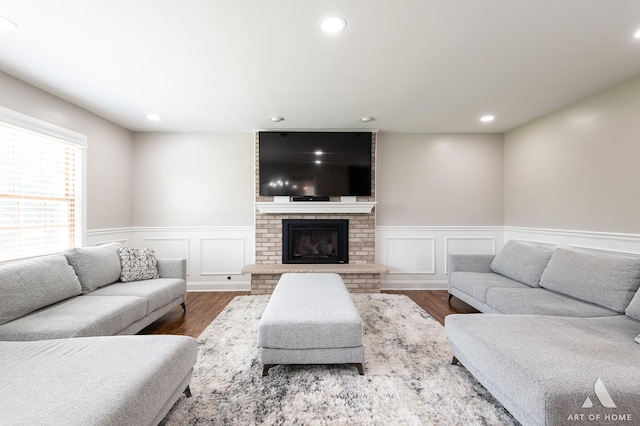 8619 Koehler Dr, Tinley Park, IL 60487 - living area featuring wood finished floors, wainscoting, recessed lighting, a brick fireplace, and a decorative wall