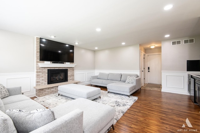 8619 Koehler Dr, Tinley Park, IL 60487 - living area with a brick fireplace, wainscoting, a decorative wall, dark wood-style flooring, and wine cooler