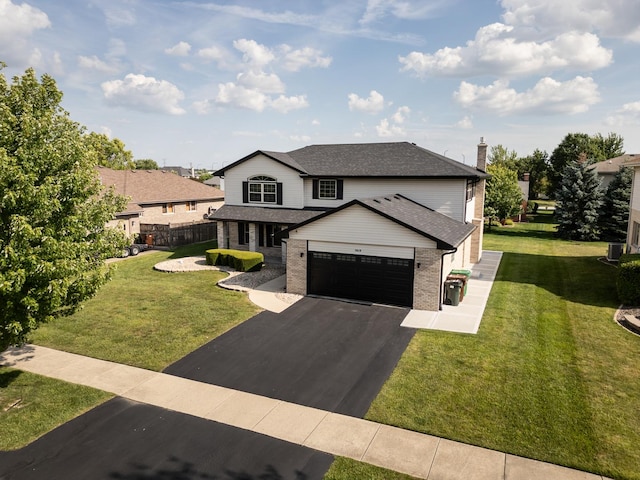 8619 Koehler Dr, Tinley Park, IL 60487 - view of front facade with asphalt driveway, brick siding, a front yard, and a garage