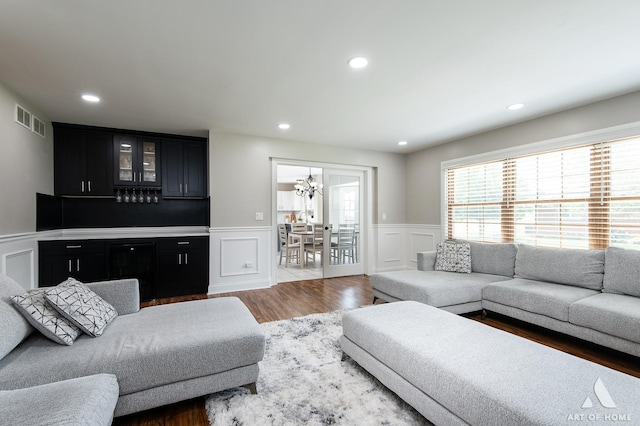 8619 Koehler Dr, Tinley Park, IL 60487 - living area featuring a decorative wall, wainscoting, wood finished floors, recessed lighting, and a chandelier