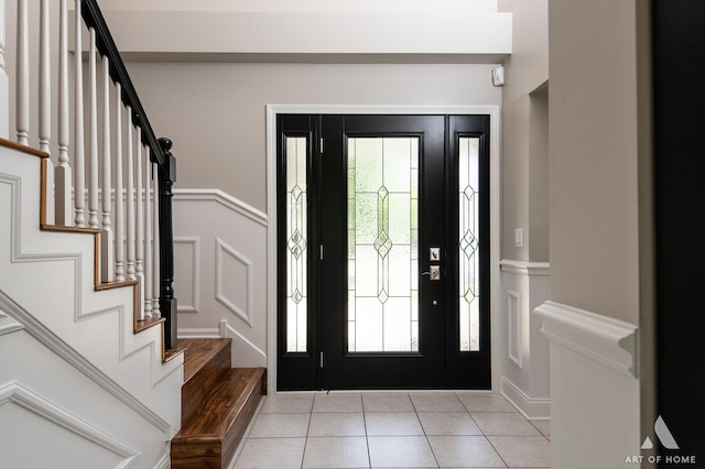 8619 Koehler Dr, Tinley Park, IL 60487 - foyer with a decorative wall, stairs, light tile patterned floors, and wainscoting