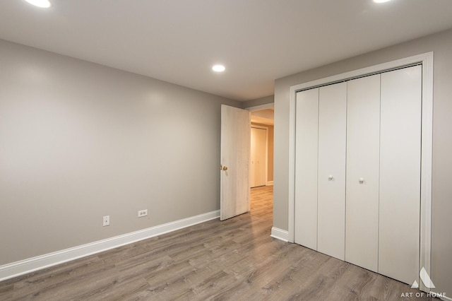 8619 Koehler Dr, Tinley Park, IL 60487 - unfurnished bedroom with recessed lighting, light wood-style floors, and a closet