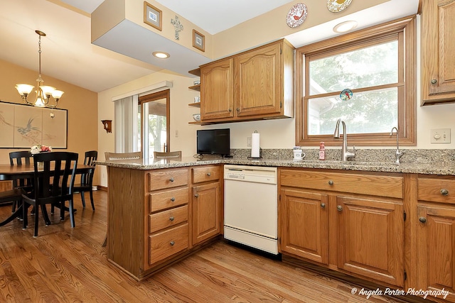 3406 W Bretons Dr, Mchenry, IL 60050 - kitchen featuring white dishwasher, light wood-style flooring, a peninsula, light stone countertops, and vaulted ceiling