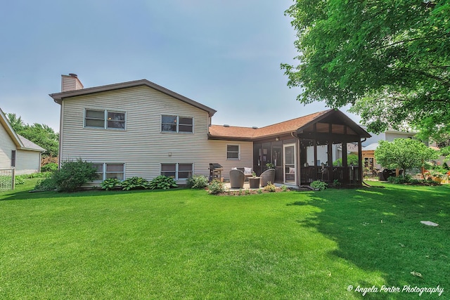 3406 W Bretons Dr, Mchenry, IL 60050 - back of house featuring a sunroom, a chimney, and a lawn