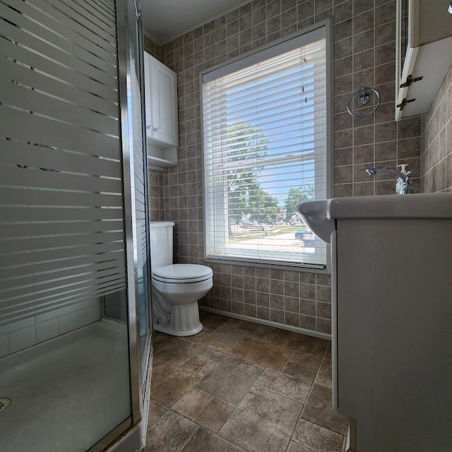 700 W Lafayette St, Ottawa, IL 61350 - full bath featuring tile walls, a shower stall, stone finish flooring, and vanity