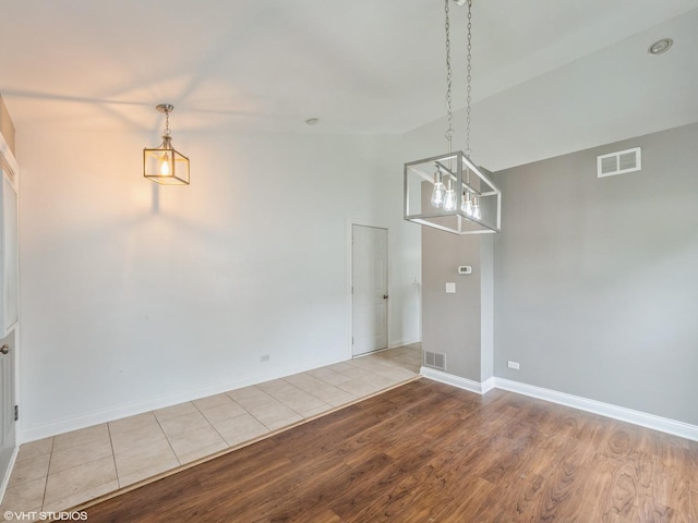 11880 Everglades Rd, Huntley, IL 60142 - unfurnished dining area with light wood finished floors and a chandelier