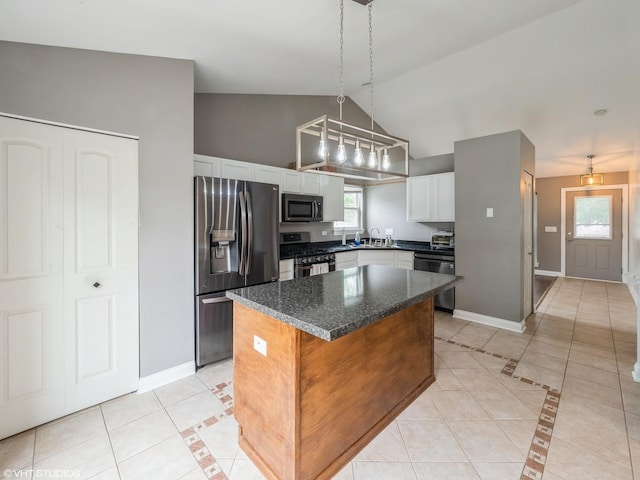 11880 Everglades Rd, Huntley, IL 60142 - kitchen featuring appliances with stainless steel finishes, light tile patterned floors, a kitchen island, white cabinets, and pendant lighting