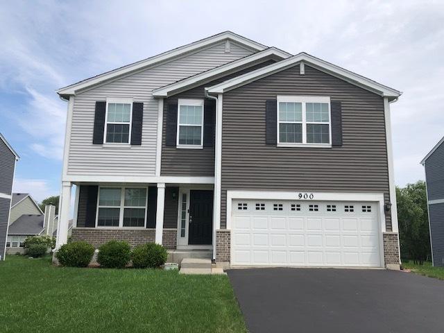 900 Heartland Park Ln, Antioch, IL 60002 - view of front facade featuring brick siding, driveway, an attached garage, and a front lawn