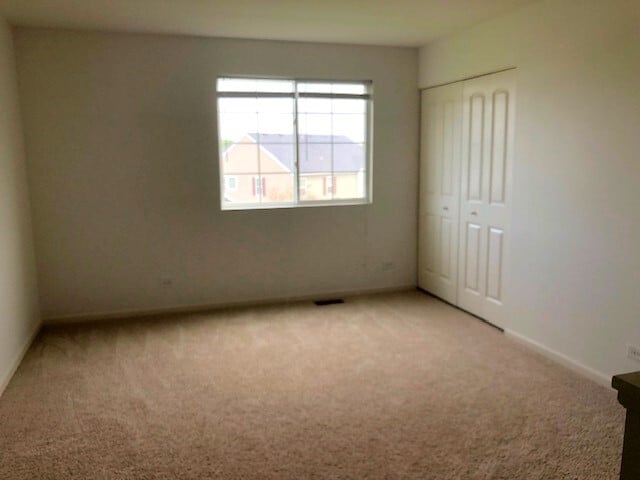 900 Heartland Park Ln, Antioch, IL 60002 - unfurnished bedroom with light carpet and a closet