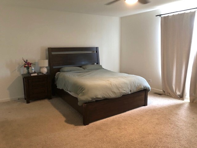 900 Heartland Park Ln, Antioch, IL 60002 - bedroom with light colored carpet and ceiling fan