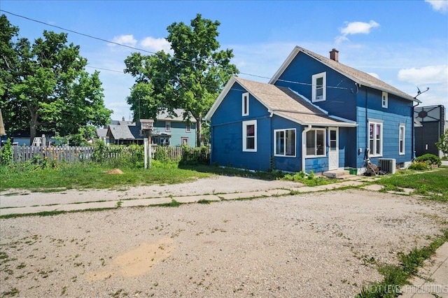 12 N Lincolnway Ave, North Aurora, IL 60542 - back of house featuring a chimney and roof with shingles