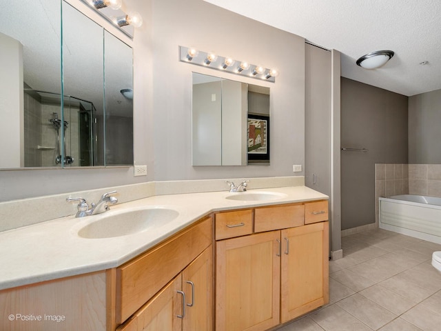 222 N Columbus Dr Unit 4803, Chicago, IL 60601 - full bathroom featuring tile patterned flooring, double vanity, a garden tub, and a textured ceiling