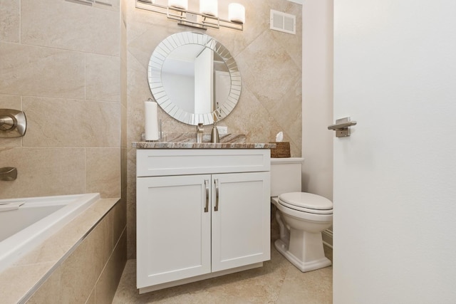 601 E 32nd St Unit 1002, Chicago, IL 60616 - full bath featuring a relaxing tiled tub, vanity, tile walls, and tile patterned flooring
