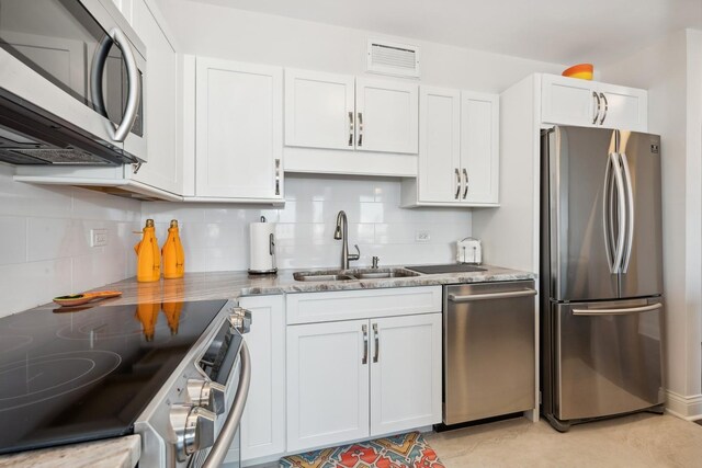 601 E 32nd St Unit 1002, Chicago, IL 60616 - kitchen with appliances with stainless steel finishes, tasteful backsplash, and white cabinets