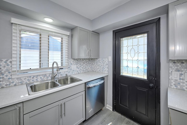 257 N Grace St, Lombard, IL 60148 - kitchen with stainless steel dishwasher, light countertops, backsplash, light wood-style floors, and gray cabinetry