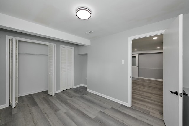 257 N Grace St, Lombard, IL 60148 - unfurnished bedroom featuring wood finished floors, recessed lighting, and two closets