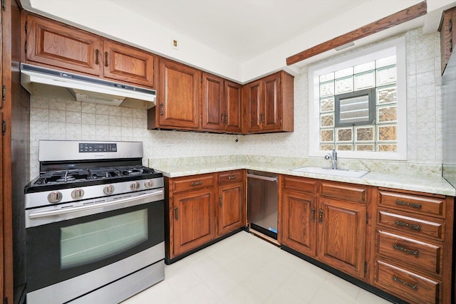 3901 N Neva Ave, Chicago, IL 60634 - kitchen with appliances with stainless steel finishes, under cabinet range hood, tasteful backsplash, brown cabinets, and light floors
