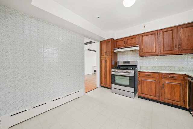 3901 N Neva Ave, Chicago, IL 60634 - kitchen featuring stainless steel gas range, a baseboard heating unit, under cabinet range hood, light countertops, and brown cabinetry