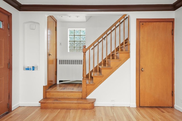 3901 N Neva Ave, Chicago, IL 60634 - foyer featuring radiator, wood finished floors, and stairway