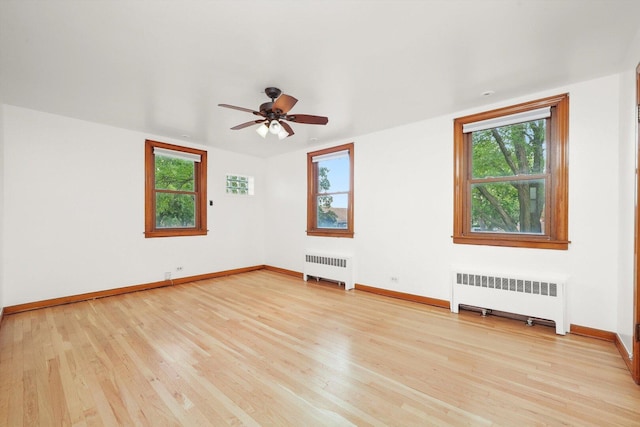 3901 N Neva Ave, Chicago, IL 60634 - spare room with radiator, plenty of natural light, and light wood finished floors