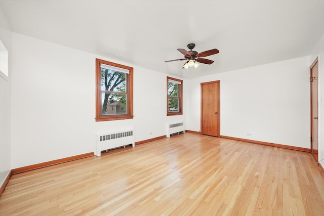 3901 N Neva Ave, Chicago, IL 60634 - empty room featuring radiator, light wood-style floors, and ceiling fan