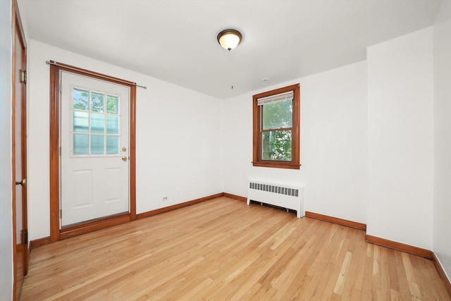 3901 N Neva Ave, Chicago, IL 60634 - spare room featuring radiator, light wood-type flooring, and healthy amount of natural light