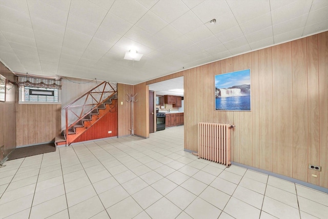 3901 N Neva Ave, Chicago, IL 60634 - below grade area with radiator, wooden walls, and stairs