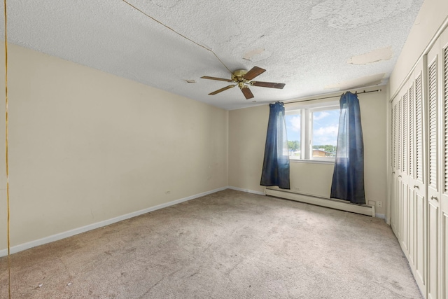 119 Boardwalk St Unit 1W, Elk Grove Village, IL 60007 - unfurnished bedroom featuring a baseboard radiator, light carpet, a ceiling fan, a closet, and a textured ceiling