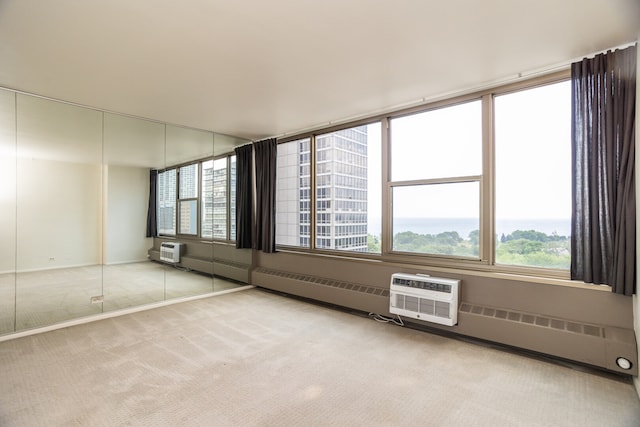 360 W Wellington Ave Unit 13E, Chicago, IL 60657 - carpeted empty room with a wall mounted air conditioner and baseboard heating