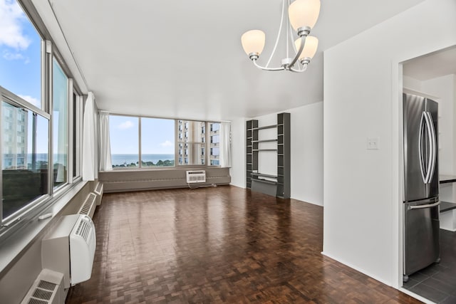 360 W Wellington Ave Unit 13E, Chicago, IL 60657 - unfurnished dining area with a chandelier and a wall mounted AC