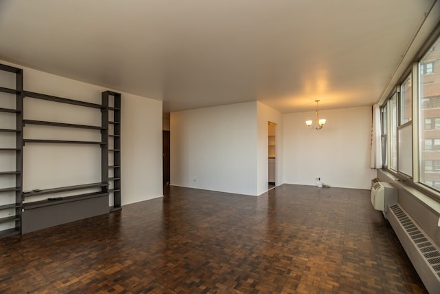 360 W Wellington Ave Unit 13E, Chicago, IL 60657 - unfurnished living room featuring a chandelier, radiator, and a wall unit AC