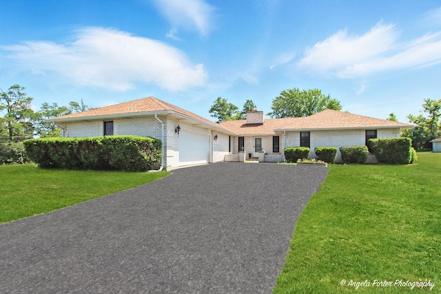 22039 W N Ave, Antioch, IL 60002 - ranch-style home featuring a garage, brick siding, driveway, a chimney, and a front lawn