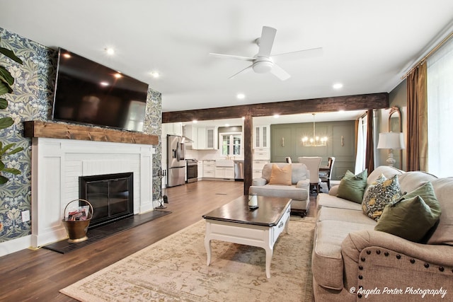 22039 W N Ave, Antioch, IL 60002 - living area featuring wood finished floors, a chandelier, a ceiling fan, a brick fireplace, and recessed lighting