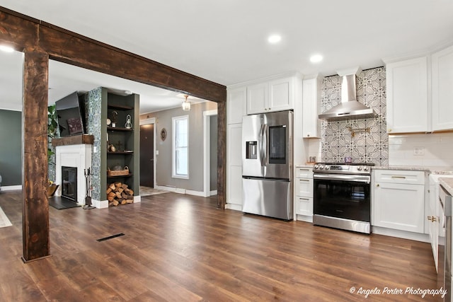 22039 W N Ave, Antioch, IL 60002 - kitchen with appliances with stainless steel finishes, wall chimney range hood, tasteful backsplash, white cabinetry, and recessed lighting