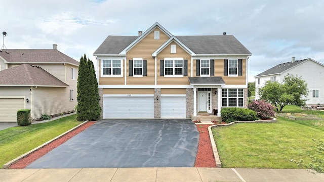 1793 Lanyon Dr, Bartlett, IL 60103 - traditional-style home featuring asphalt driveway, an attached garage, a front yard, and roof with shingles