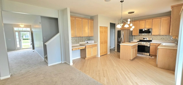 1793 Lanyon Dr, Bartlett, IL 60103 - kitchen featuring stainless steel appliances, decorative backsplash, a center island, light countertops, and decorative light fixtures