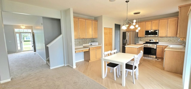 1793 Lanyon Dr, Bartlett, IL 60103 - kitchen featuring stainless steel appliances, tasteful backsplash, a kitchen island, light countertops, and decorative light fixtures