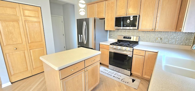 1793 Lanyon Dr, Bartlett, IL 60103 - kitchen with stainless steel appliances, light brown cabinets, light wood-style flooring, and light countertops