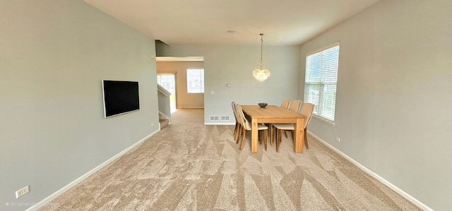1793 Lanyon Dr, Bartlett, IL 60103 - dining area with healthy amount of natural light, carpet flooring, a chandelier, and stairs