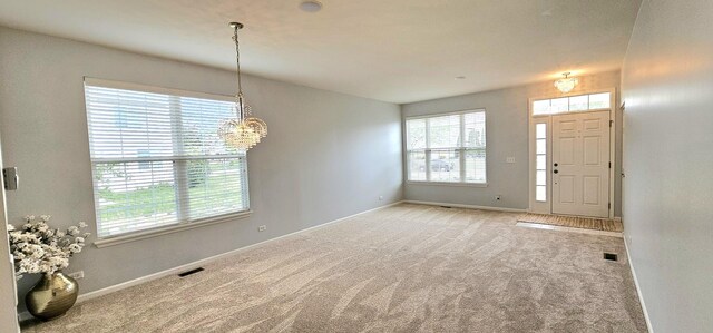 1793 Lanyon Dr, Bartlett, IL 60103 - carpeted foyer featuring healthy amount of natural light and a chandelier